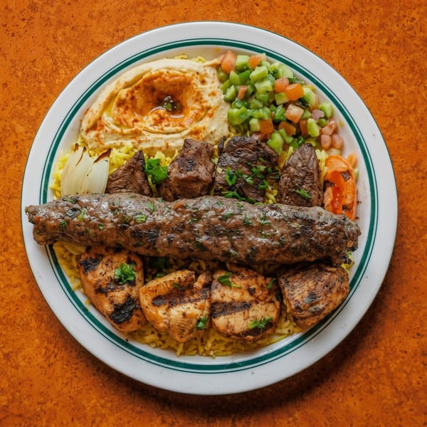 A platter of grilled chicken, beef, and kofta kebabs with rice, hummus, and chopped salad.
